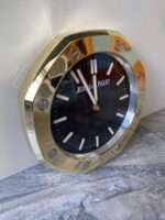 Luxurious stainless steel wall clock based on yellow gold bezel and black face