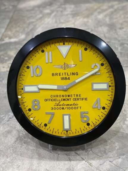 Luxurious stainless steel wall clock based on satin black bezel and yellow face
