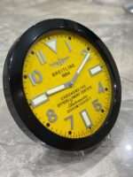 Luxurious stainless steel wall clock based on satin black bezel and yellow face