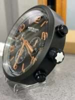High-quality wall clock MONTBLANC with matt black bezel black face with orange dial