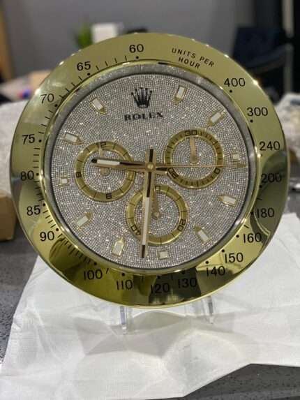 Luxurious stainless steel wall clock. DAYTONA in yellow gold bezel and diamond face